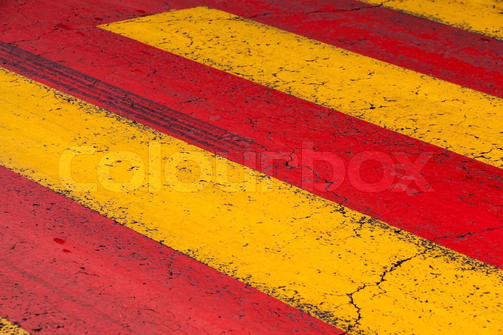Pedestrian crossing road marking with yellow and red lines o