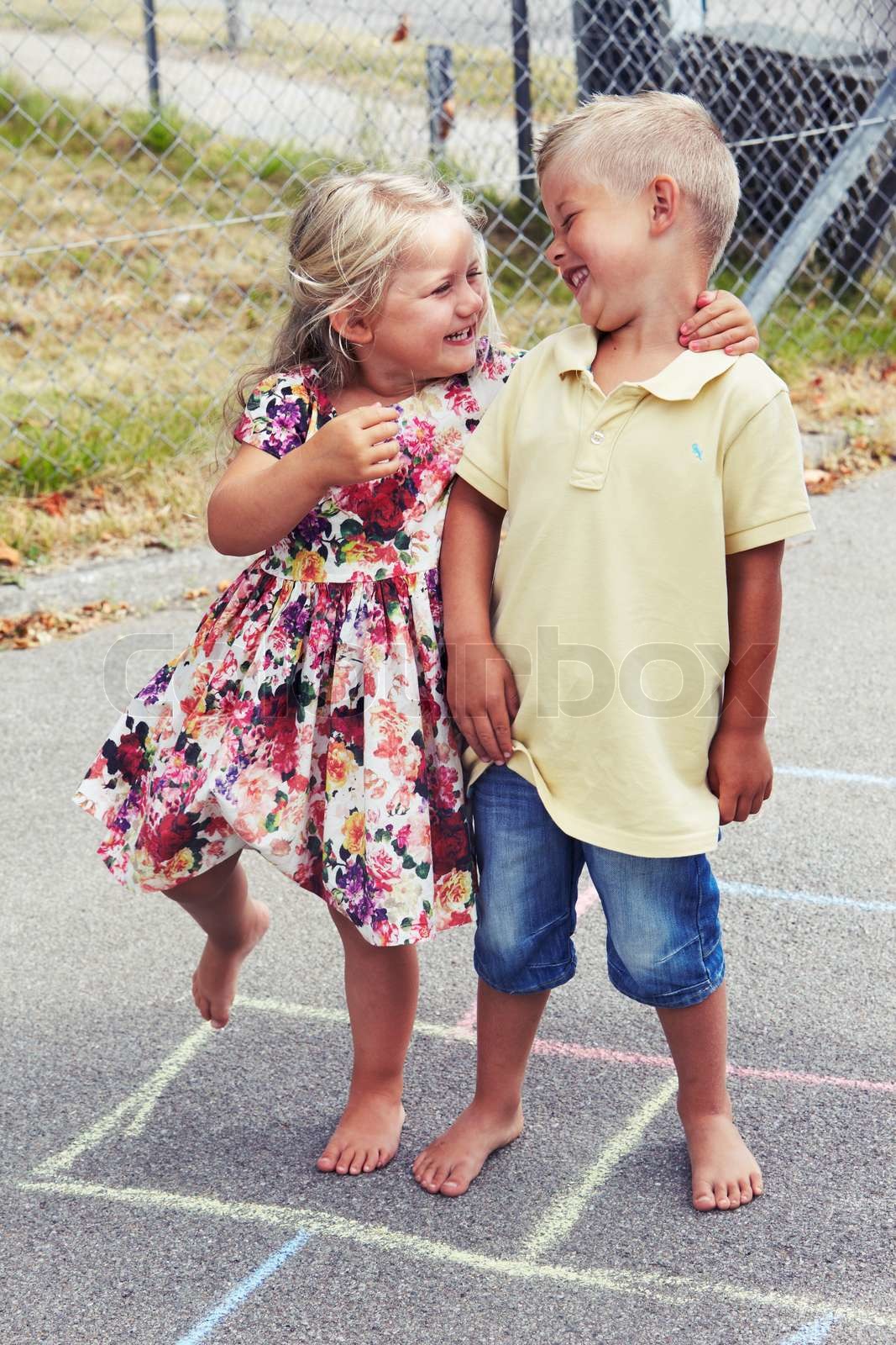 Young girl and boy playing hopscotch smiling Colourbox