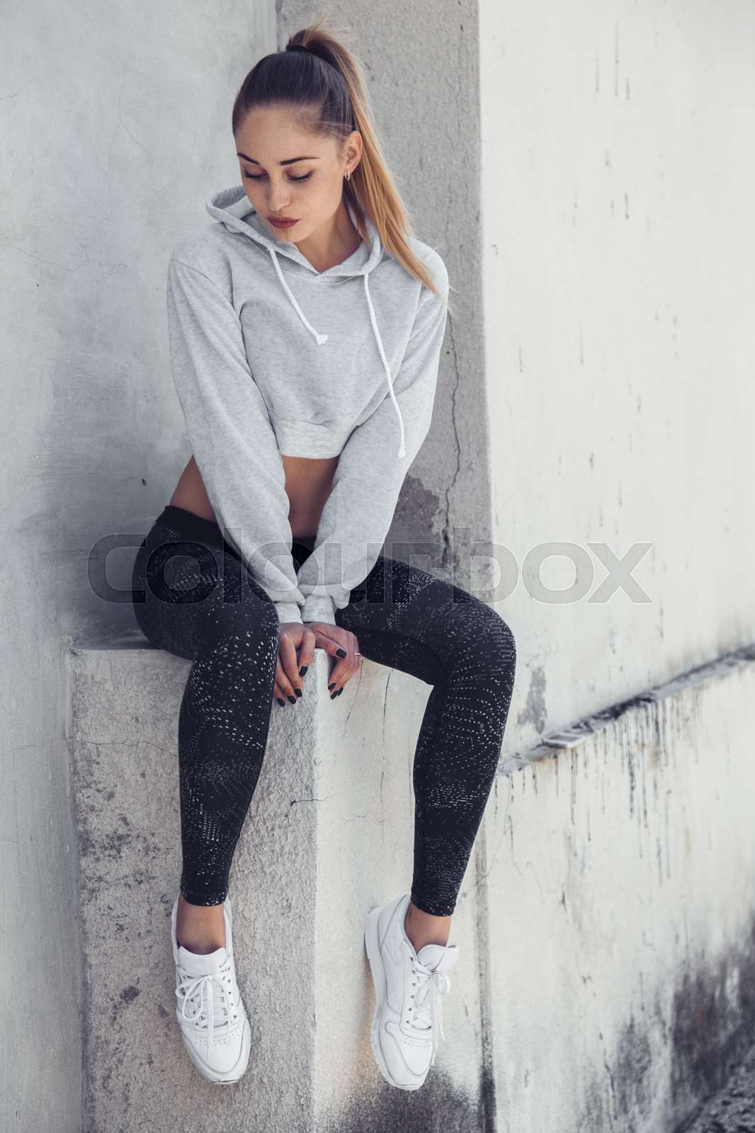 Fitness sporty girl wearing fashion sportswear over street w Colourbox