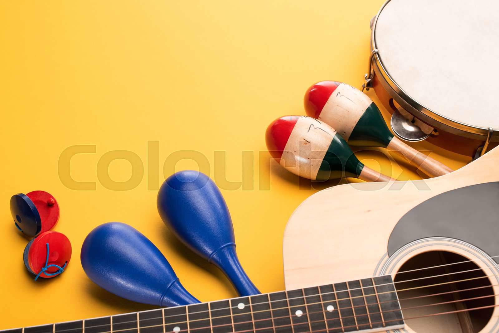 Wooden colorful and blue maracas with tambourine castanets Colourbox