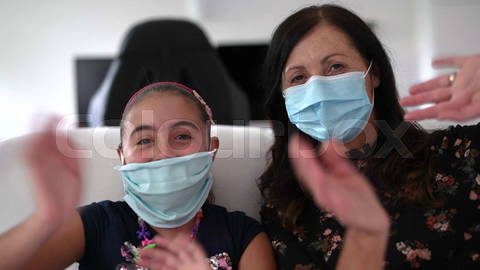 Webcam view of little girl with mother during a videocall wi |            Colourbox        
