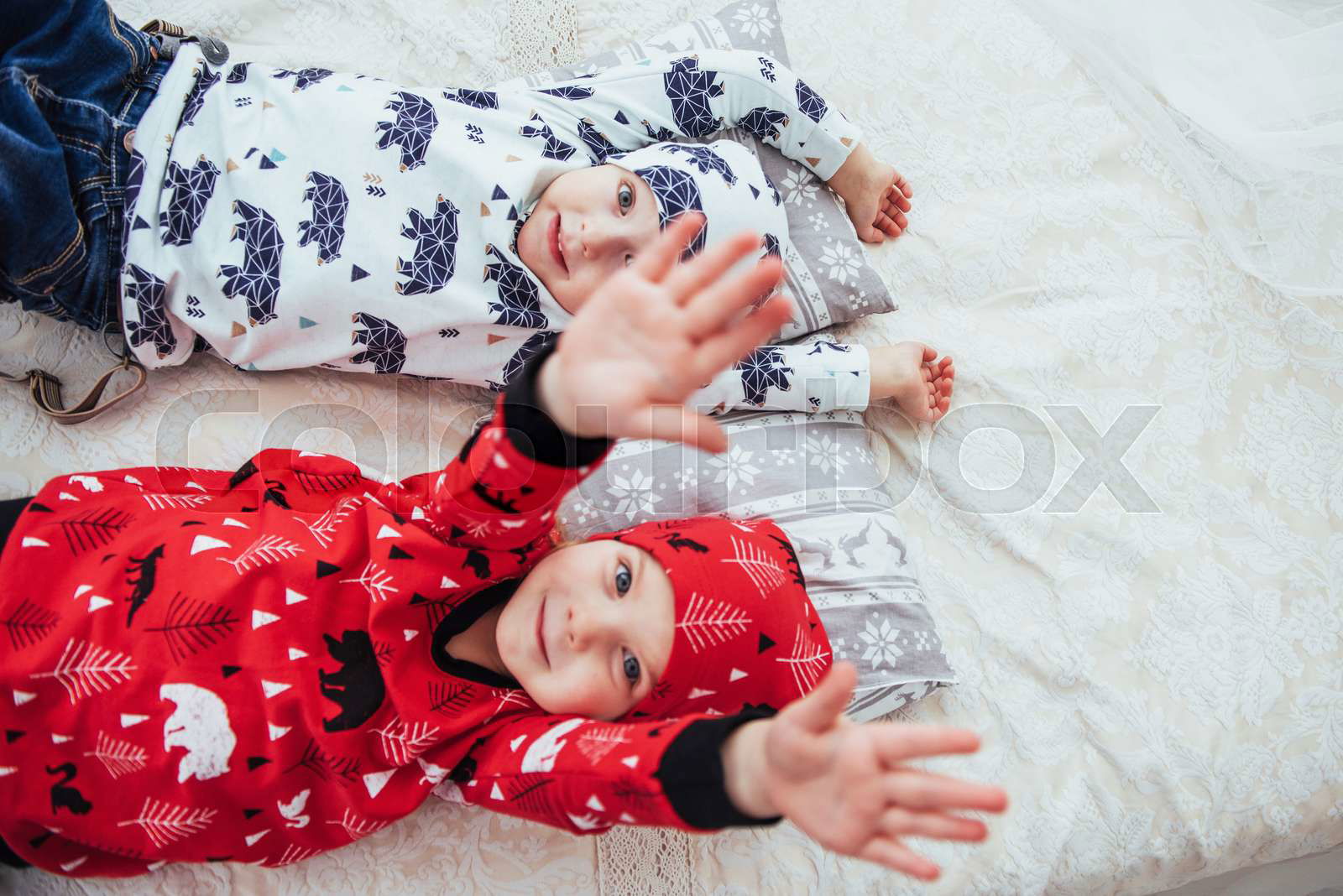 Child in soft warm pajama playing in bed. In good light stud Colourbox
