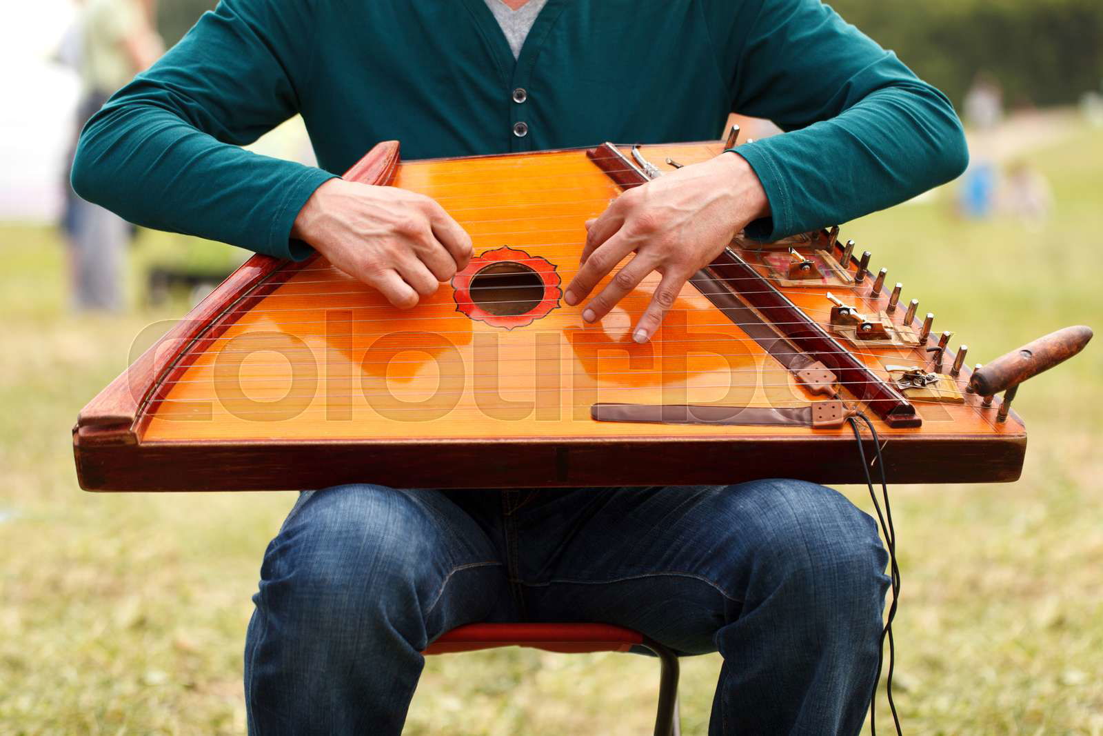 Man playing on gusli instrument. Gusli is an ancient traditi Colourbox