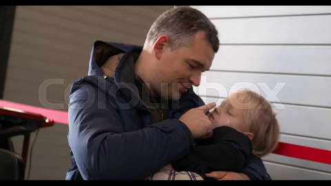Father with daughter sleeping on his laps waiting at the sta |            Colourbox        