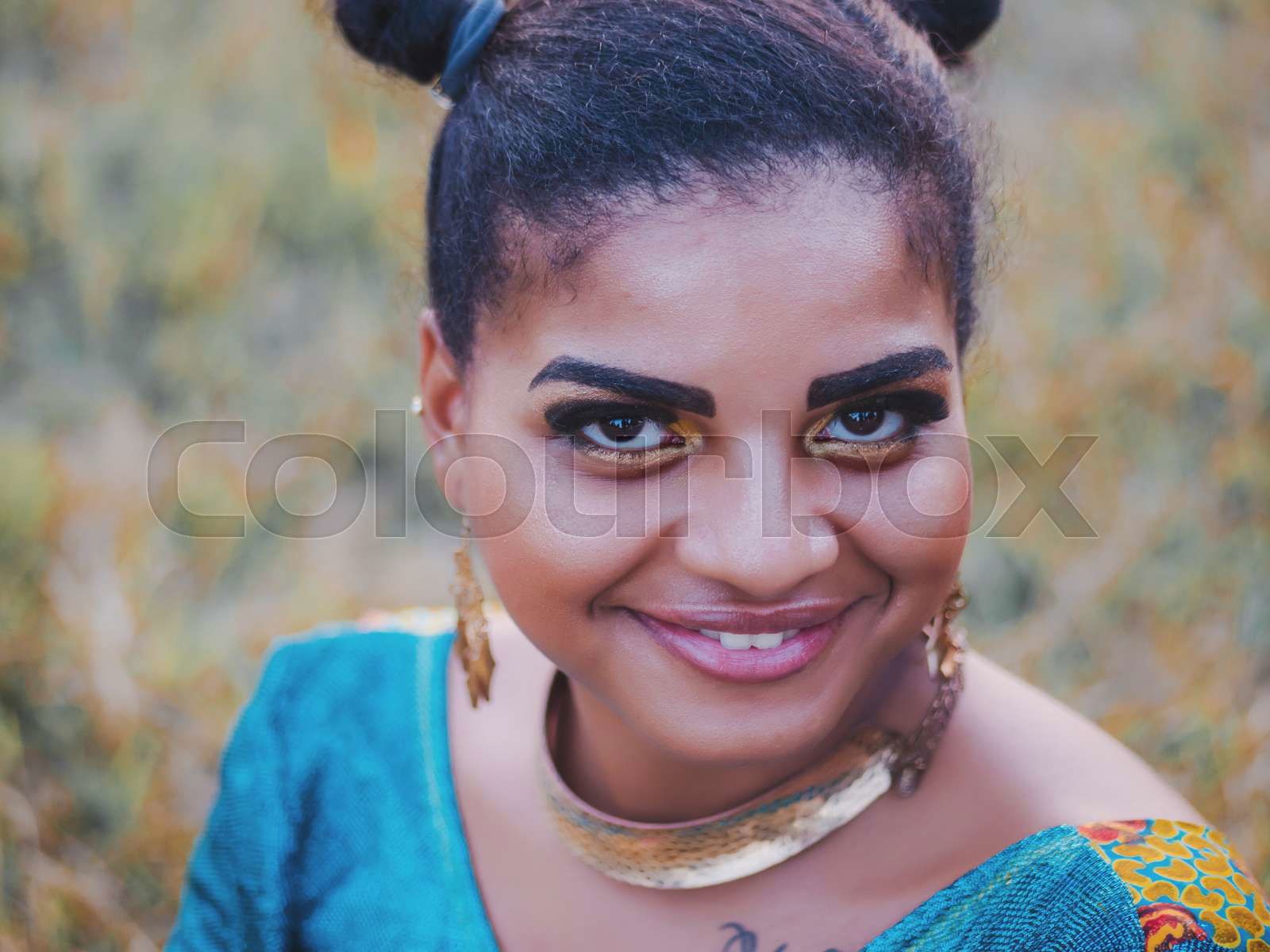 Portrait of young afro american gypsy woman in colorful blue Colourbox