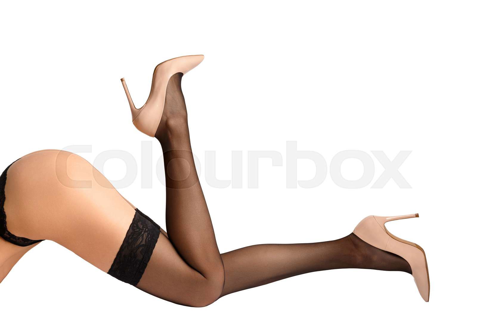 Slender female legs in black stockings with a beautiful open Colourbox