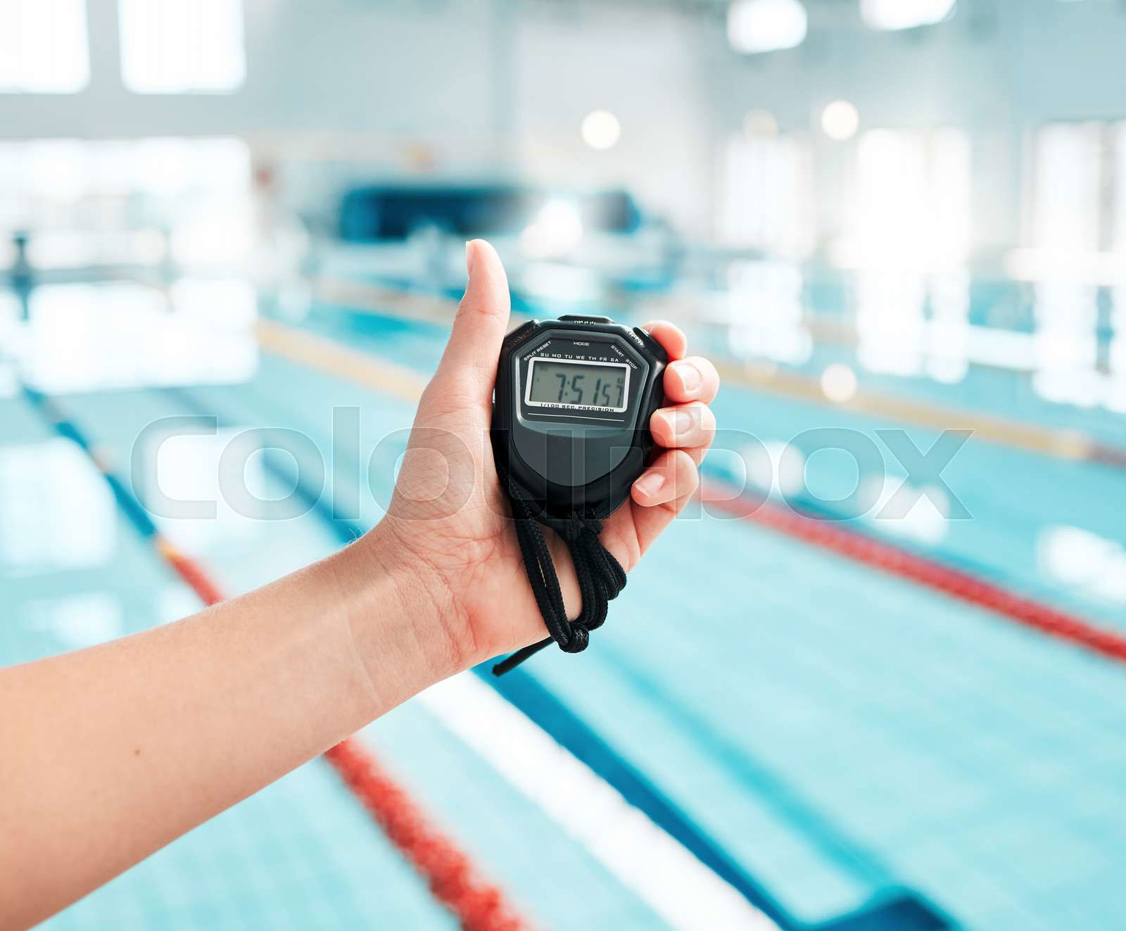 Person hand and stopwatch by pool in swimming race or spor Colourbox