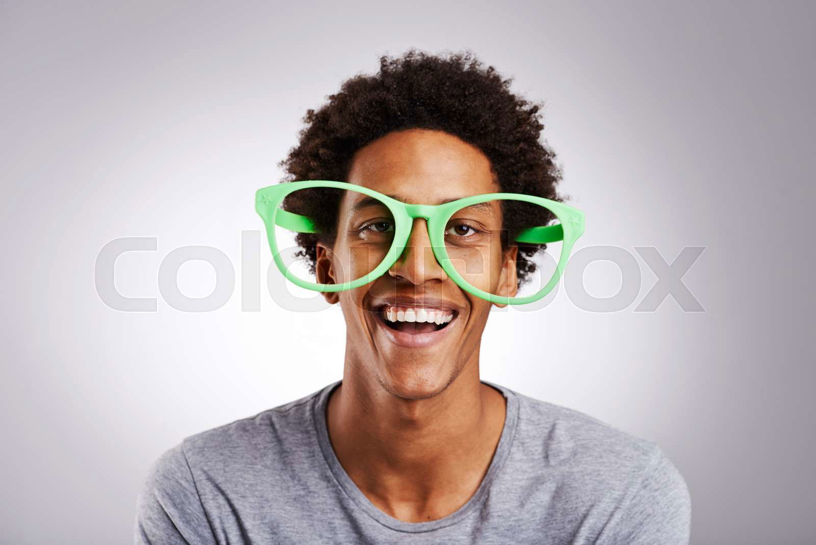 Funny big glasses and black man with a smile happy and fun Colourbox