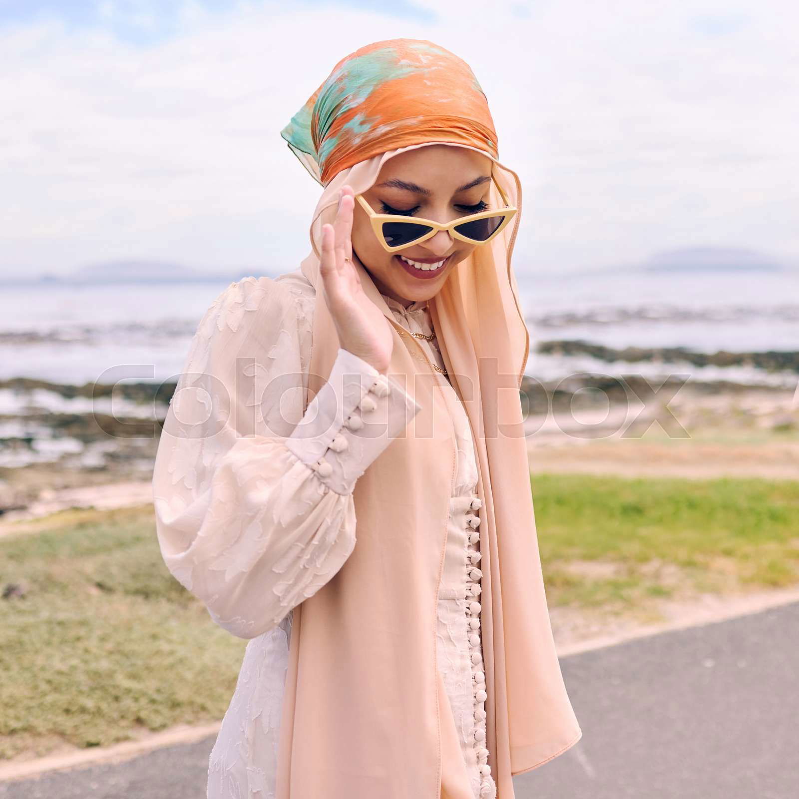 Fashion city and happy Muslim woman by sea with style tren Colourbox