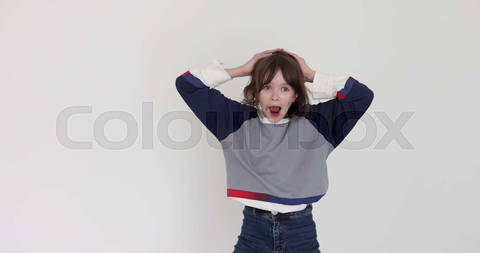 Teen schoolgirl screams Wow touching head on white ...
